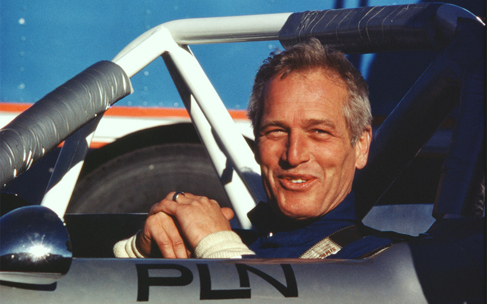 Vivid magic hour color photograph of Paul Newman in his race car at Pocono International Raceway, in May of 1977, photograph ©Steve Landis