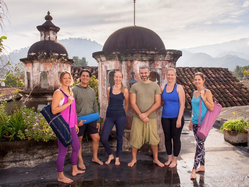 outdoor location group photo of teachers and students from YogAntigua yoga studio on the roof of Panza Verde restaurant